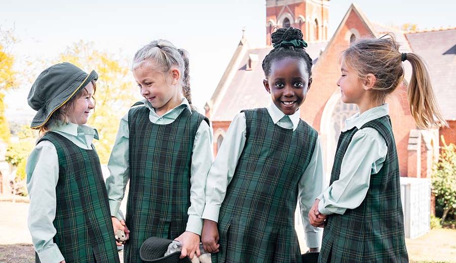 Junior school students playing outside together